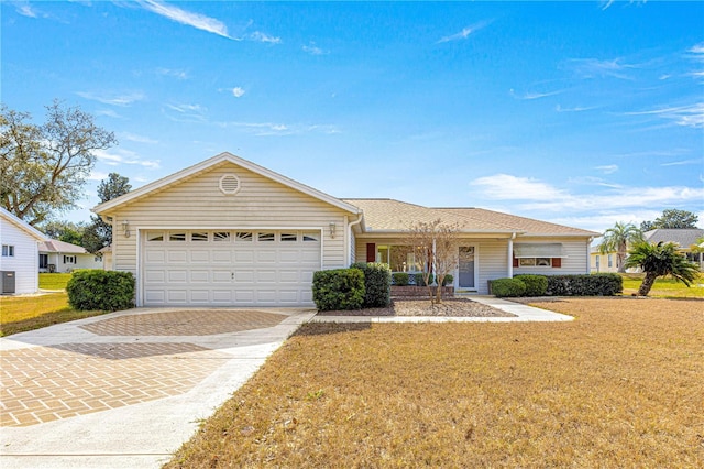 ranch-style house with central AC unit, a garage, and a front lawn