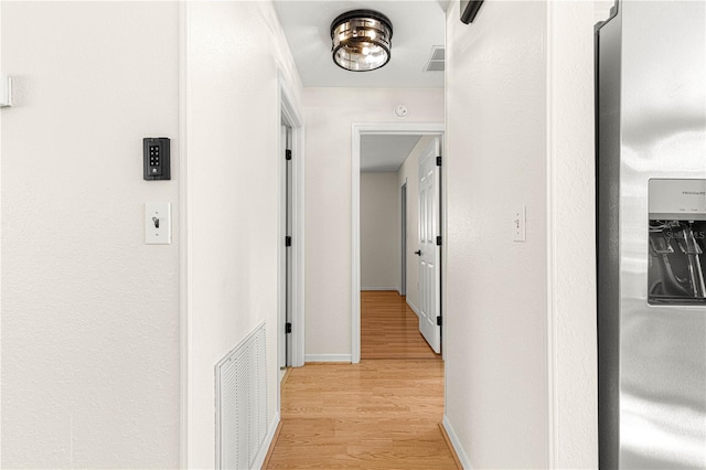 hallway with light hardwood / wood-style flooring