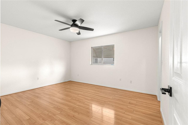 empty room with ceiling fan and light hardwood / wood-style floors