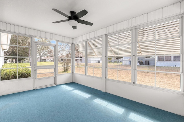 unfurnished sunroom featuring ceiling fan