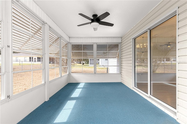 unfurnished sunroom with ceiling fan