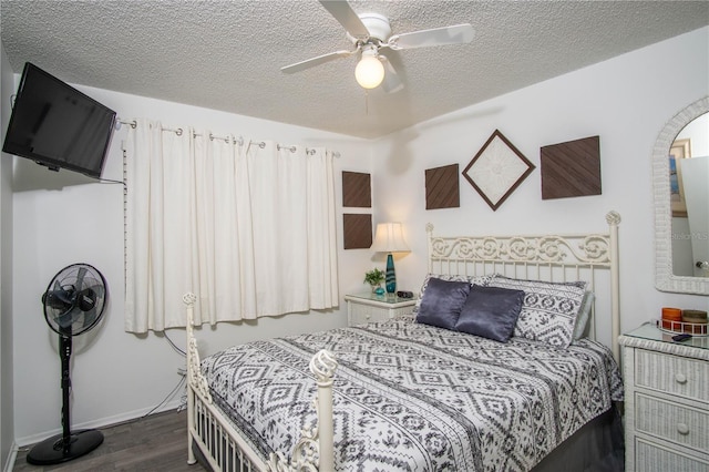 bedroom featuring a textured ceiling, ceiling fan, and dark wood-type flooring