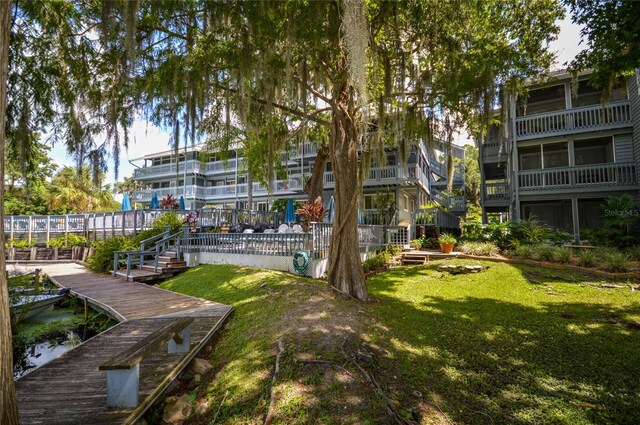 view of property's community featuring a boat dock and a yard