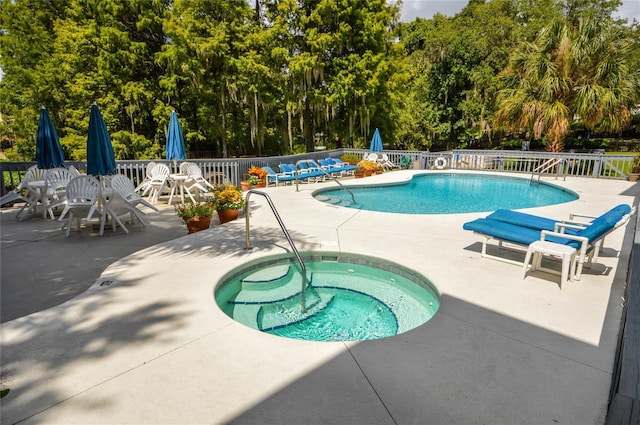 view of swimming pool featuring a patio area and a community hot tub