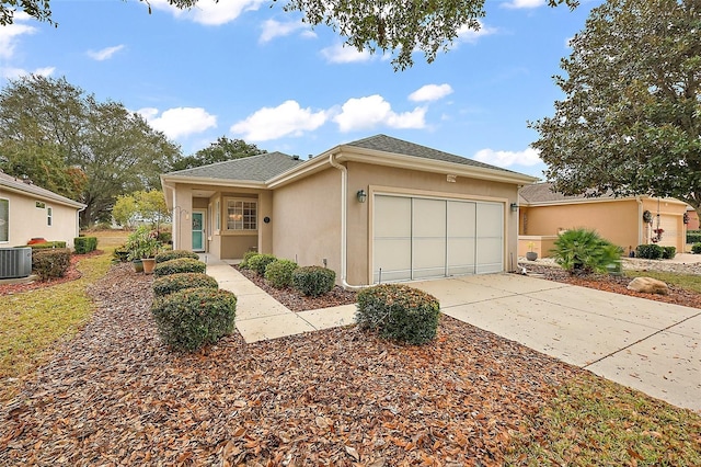 view of front of property featuring cooling unit and a garage