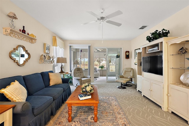 living room featuring ceiling fan and carpet