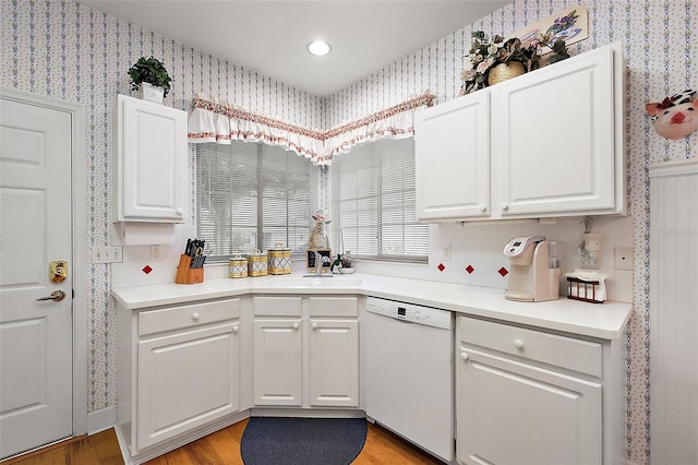 kitchen featuring dishwasher, light hardwood / wood-style flooring, and white cabinetry