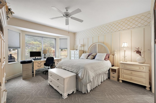 bedroom with ceiling fan and dark colored carpet