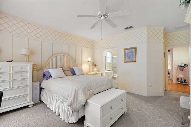 bedroom with connected bathroom, carpet flooring, and ceiling fan