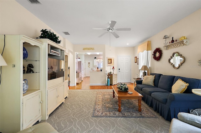 living room featuring light wood-type flooring and ceiling fan