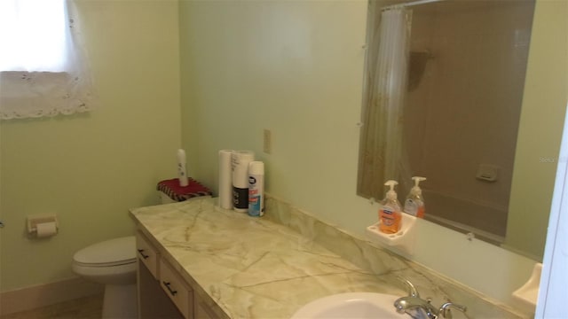 bathroom featuring vanity, toilet, and walk in shower