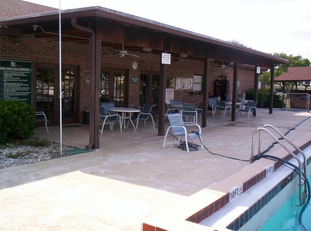 view of patio featuring french doors, ceiling fan, and a community pool