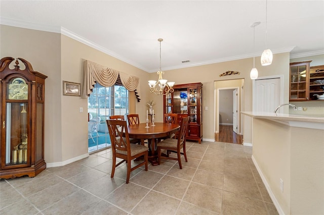 dining area featuring a chandelier, light tile patterned floors, and crown molding