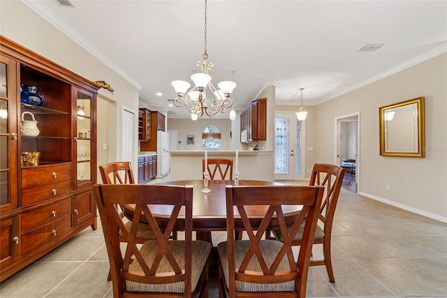 tiled dining room featuring a notable chandelier and ornamental molding