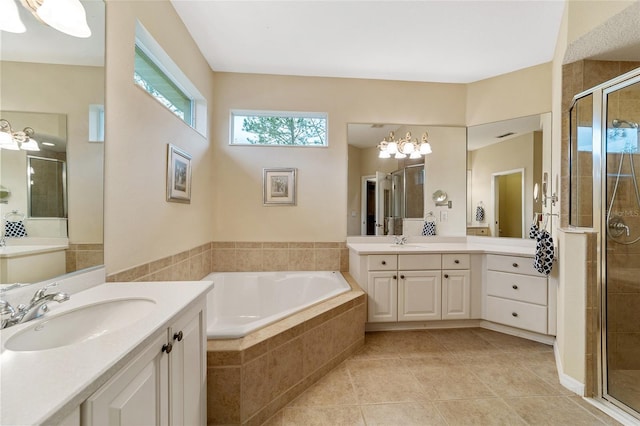 bathroom featuring vanity, shower with separate bathtub, tile patterned flooring, and an inviting chandelier