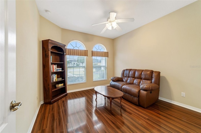 living area featuring ceiling fan and dark hardwood / wood-style floors