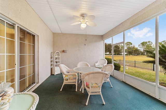 sunroom featuring ceiling fan