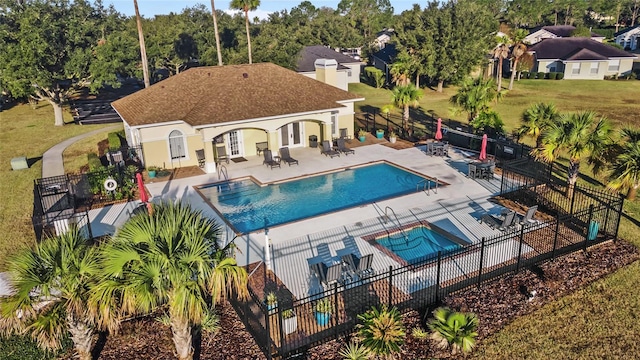 view of pool featuring a lawn, a hot tub, and a patio