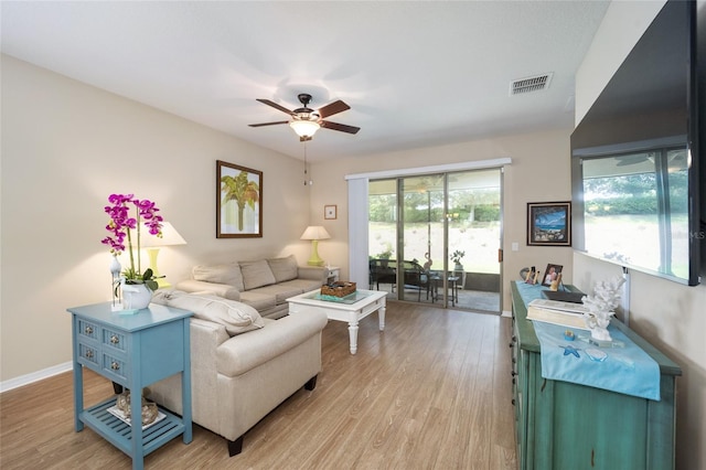 living room with ceiling fan and light hardwood / wood-style flooring