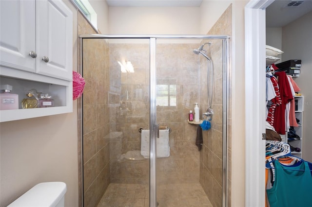 bathroom with toilet and walk in shower