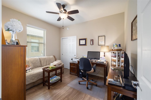 home office with hardwood / wood-style floors and ceiling fan