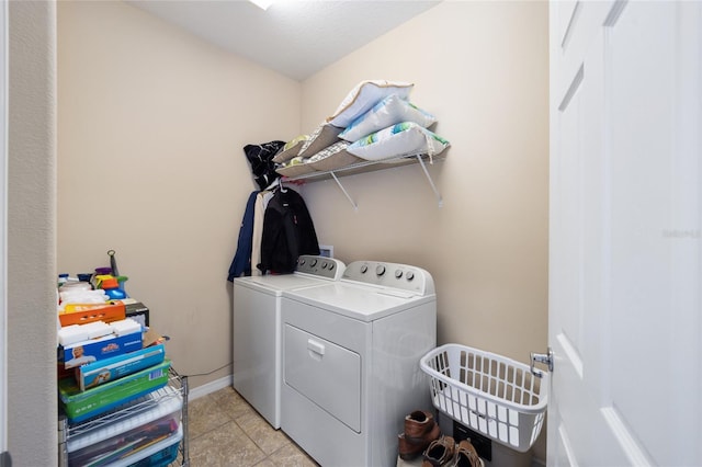 laundry room with light tile patterned floors and washing machine and clothes dryer