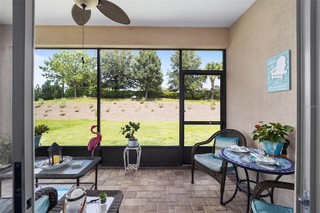 sunroom featuring ceiling fan