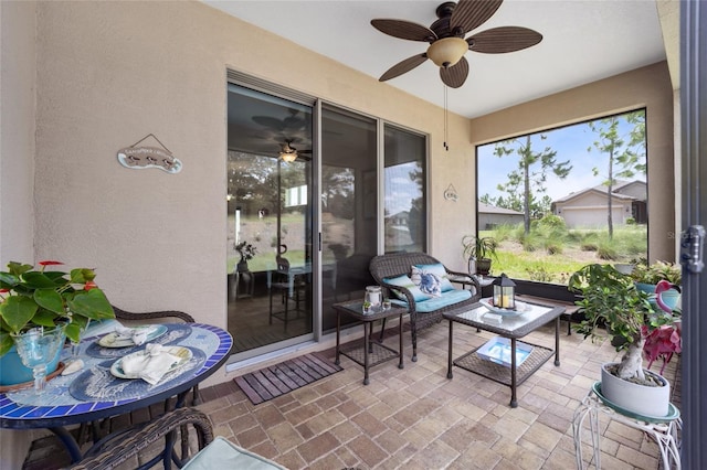 sunroom featuring ceiling fan