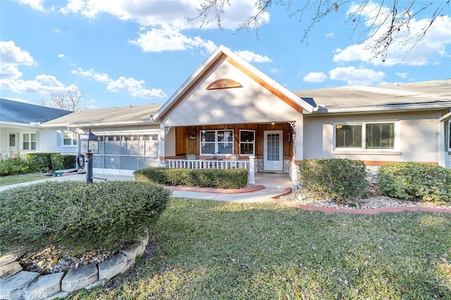 ranch-style house with a front yard and covered porch