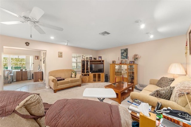 carpeted living room featuring ceiling fan and plenty of natural light