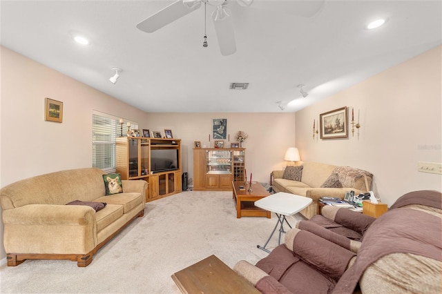 carpeted living room with ceiling fan