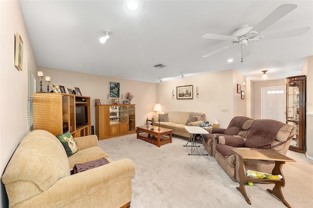 carpeted living room featuring ceiling fan