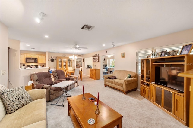 living room with light carpet and ceiling fan