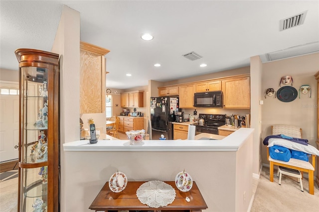 kitchen featuring kitchen peninsula, light carpet, light brown cabinets, and black appliances