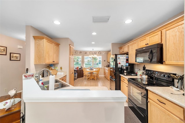 kitchen featuring sink, black appliances, light brown cabinets, a notable chandelier, and light tile patterned flooring