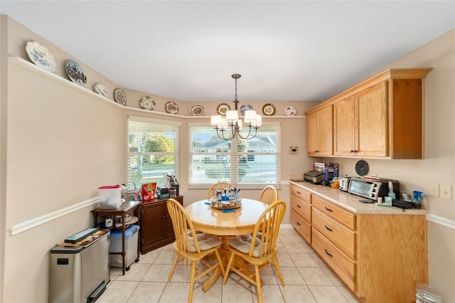 dining space featuring a healthy amount of sunlight, light tile patterned floors, and a chandelier