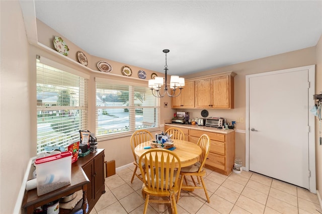 dining space with a notable chandelier and light tile patterned floors