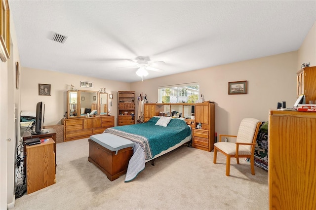 bedroom featuring ceiling fan and light carpet