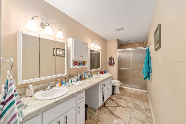 bathroom with vanity, an enclosed shower, and toilet