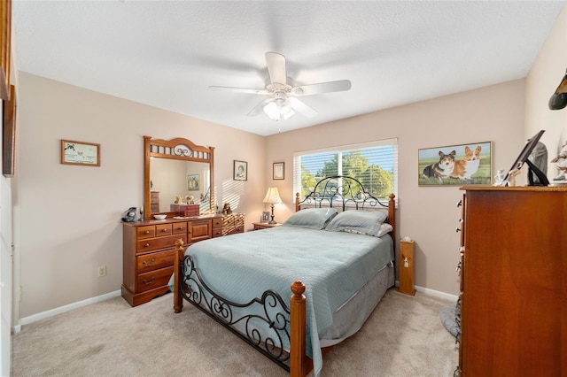 bedroom with light colored carpet and ceiling fan