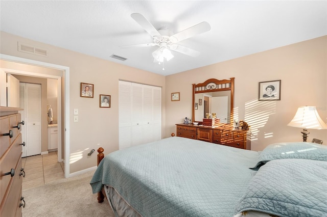 bedroom with a closet, ceiling fan, and light colored carpet