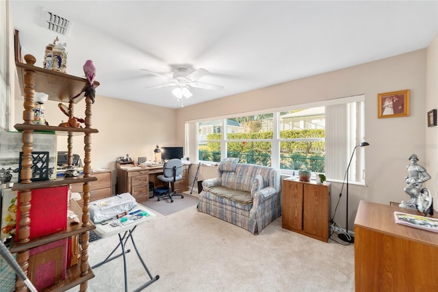 carpeted office space featuring ceiling fan