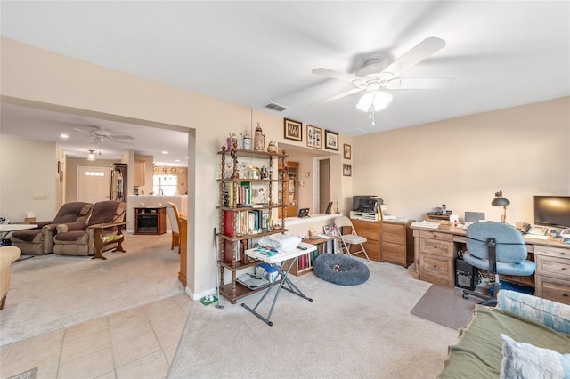 office area featuring light carpet and ceiling fan