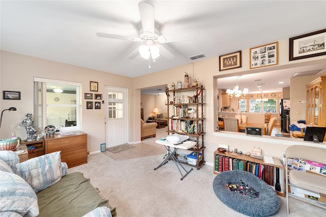 interior space with ceiling fan with notable chandelier