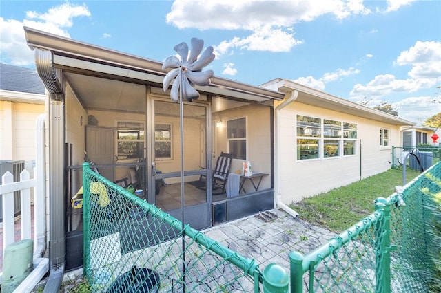 back of house with a sunroom