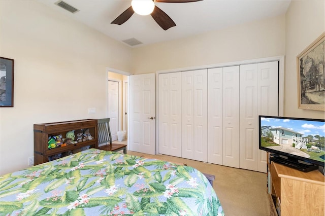 bedroom with a closet, ceiling fan, and light colored carpet