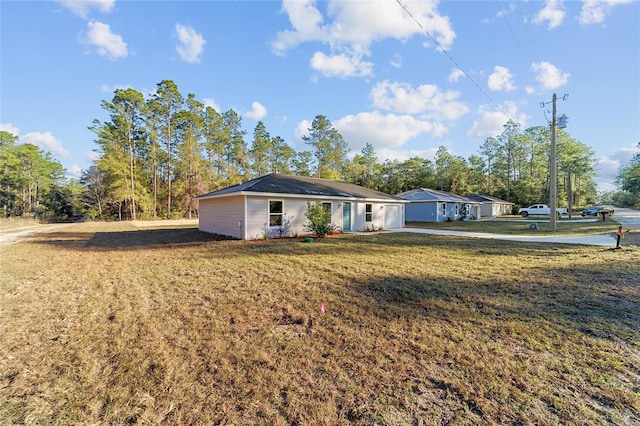 ranch-style home featuring a front yard