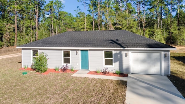 single story home featuring a front lawn and a garage