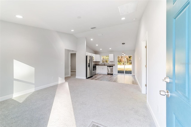 living room with light carpet and vaulted ceiling