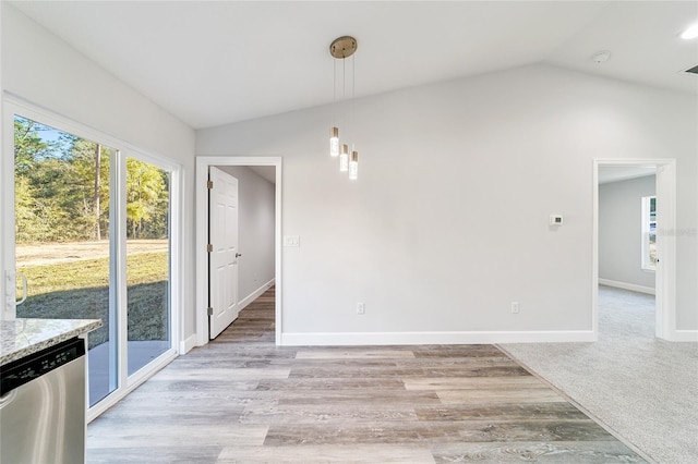 unfurnished dining area featuring light hardwood / wood-style flooring, a healthy amount of sunlight, and lofted ceiling